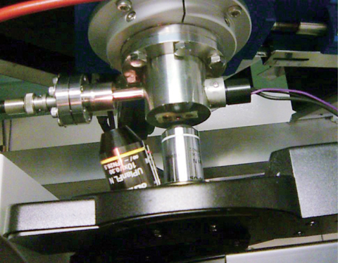 Extraction window for a micro ion beam from the cyclotron (upper portion) and a part of the microscope to observe ion-irradiation sample position (lower portion)